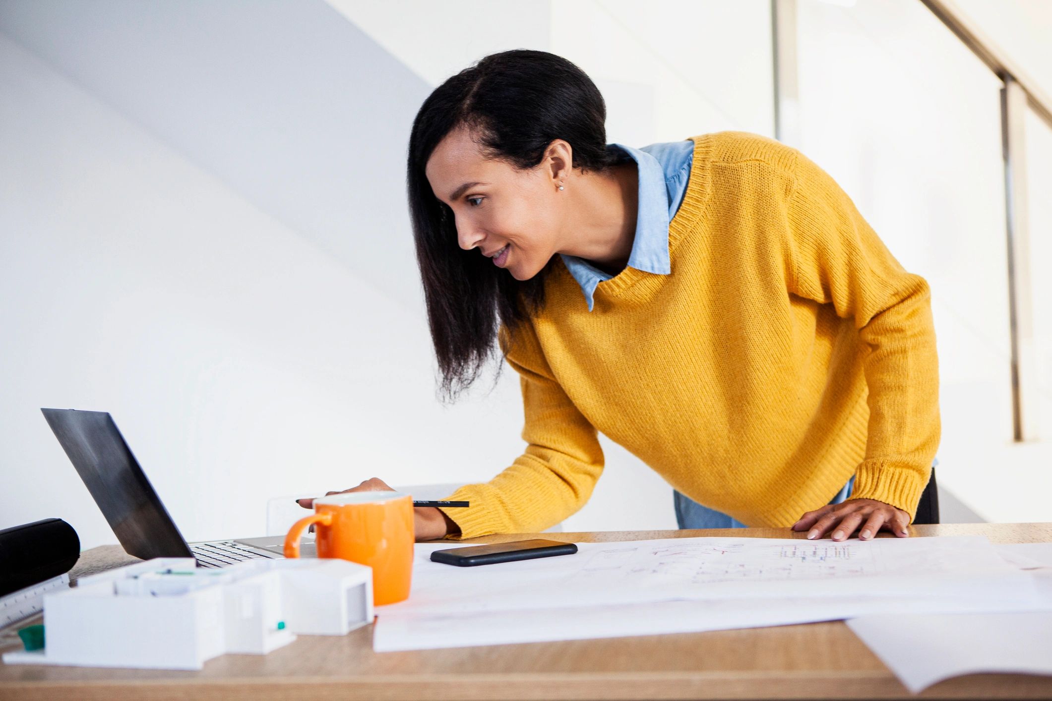 Architect working on CAD drawings in a studio