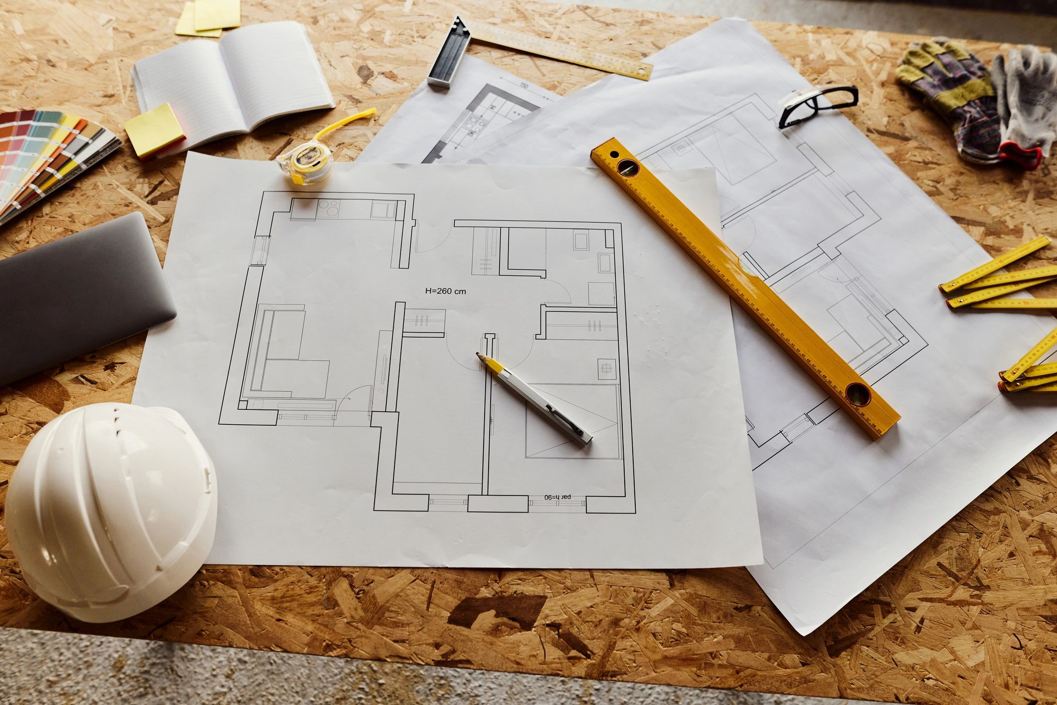 Architectural drafting tools and blueprint on a work surface