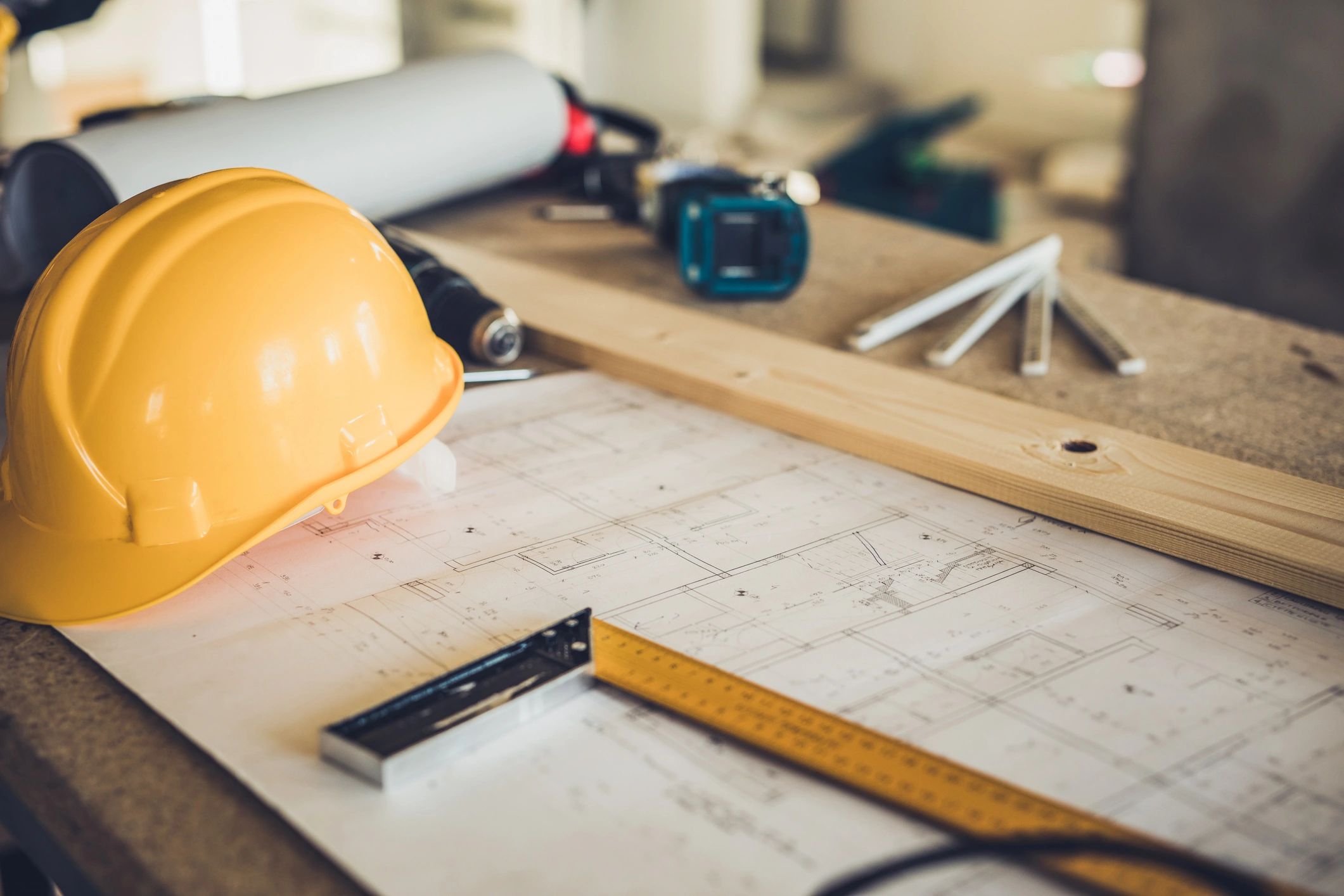 Construction plan documents and tools at a job site